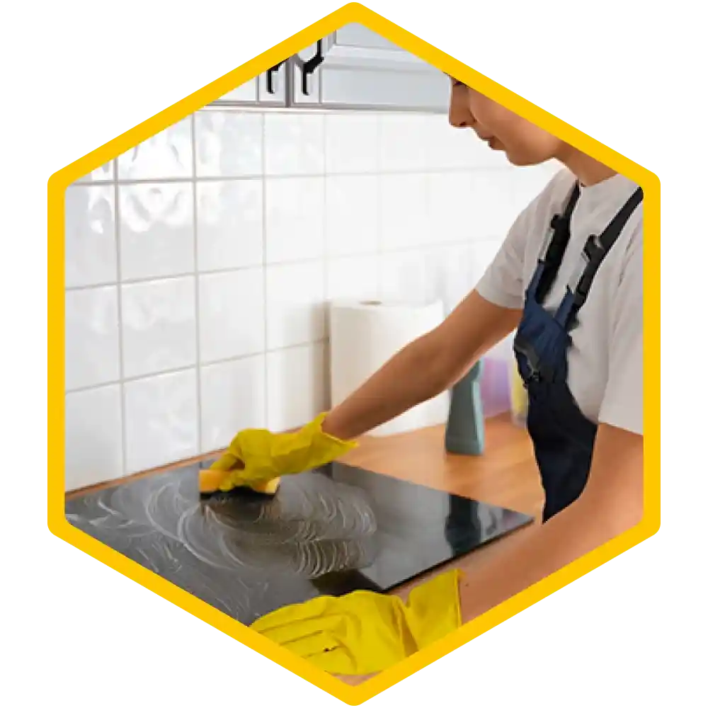 Person cleaning a kitchen counter with disinfectant.